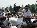 A police-woman instructing the crowd